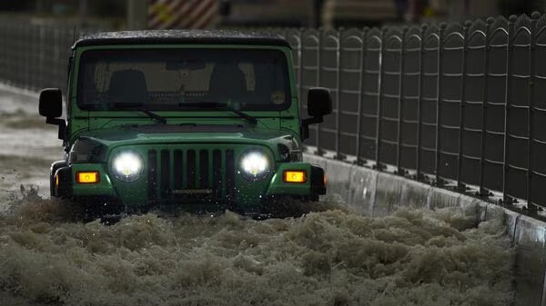 Dubai Floods: An SUV passes through standing water in Dubai, United Arab Emirates, Tuesday, April 16, 2024. Heavy rains lashed the United Arab Emirates on Tuesday, flooding out portions of major highways and leaving vehicles abandoned on roadways across Dubai. Meanwhile, the death toll in separate heavy flooding in neighboring Oman rose to 18 with others still missing as the sultanate prepared for the storm. (AP Photo/Jon Gambrell)